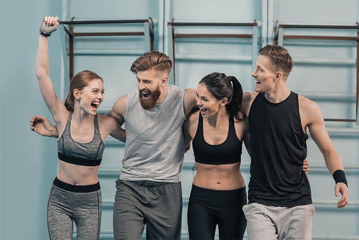 2 men and 2 women happily cheering